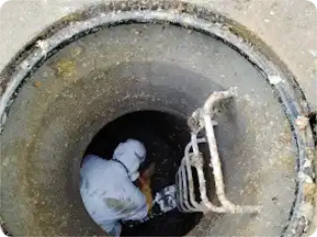 Técnico de Destapes Bravo trabajando dentro de una cámara de alcantarillado